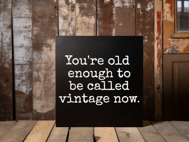 You're old enough to be called vintage now. Black sign with white lettering.