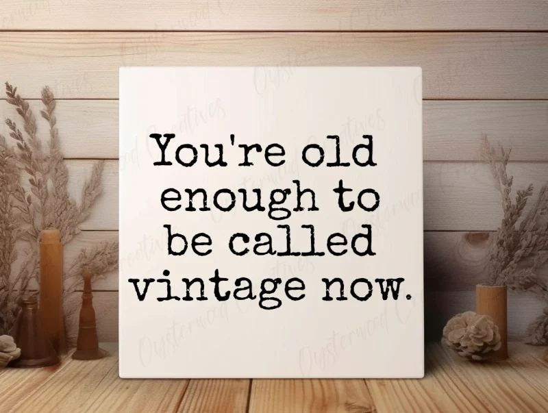 You're old enough to be called vintage now. White sign with black lettering.