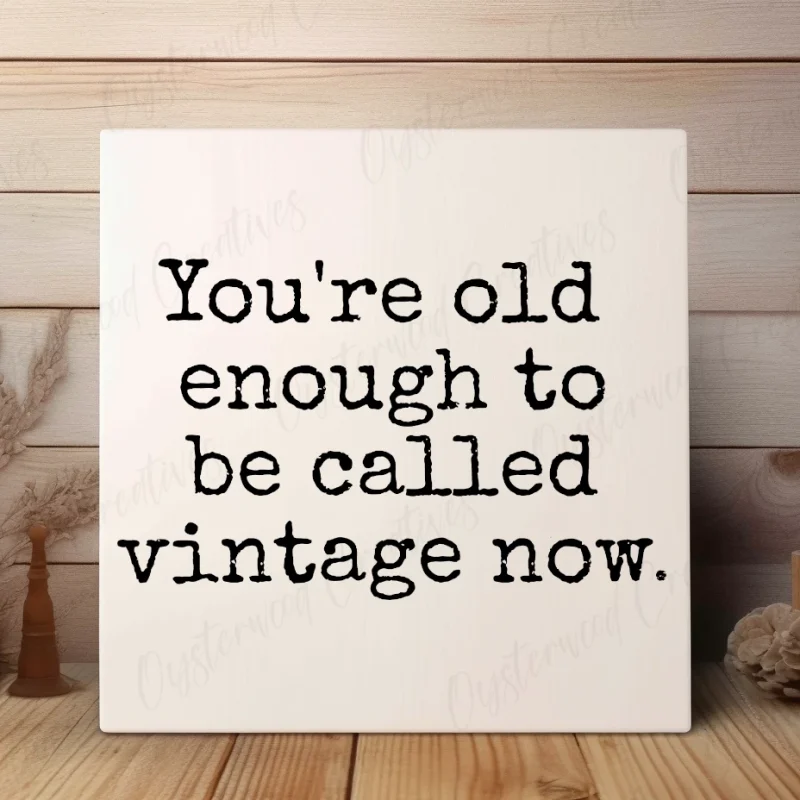 You're old enough to be called vintage now. White sign with black lettering.