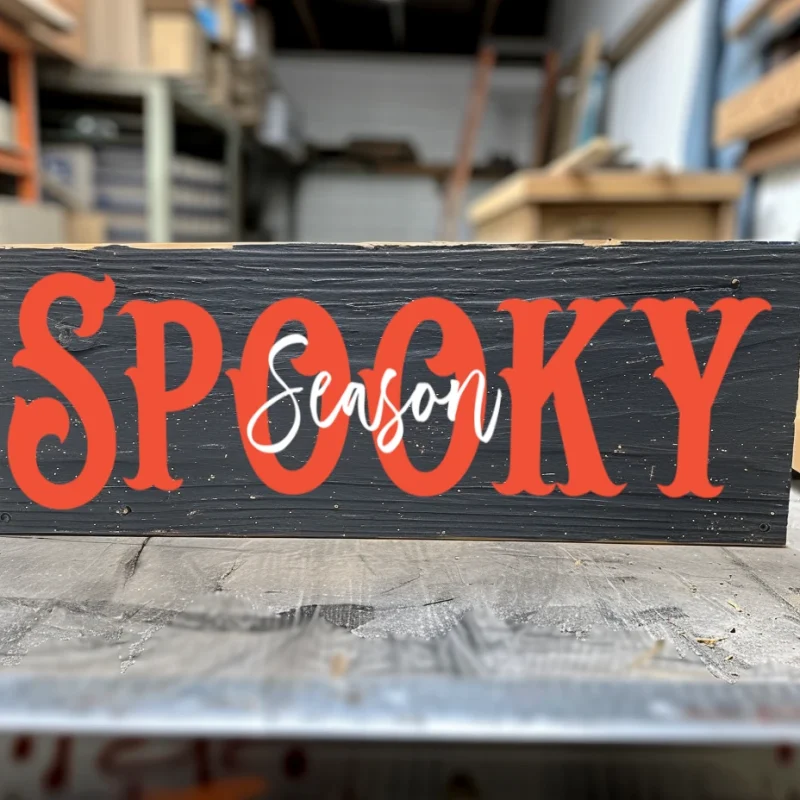 Spooky Season. Black sign with orange and white lettering.