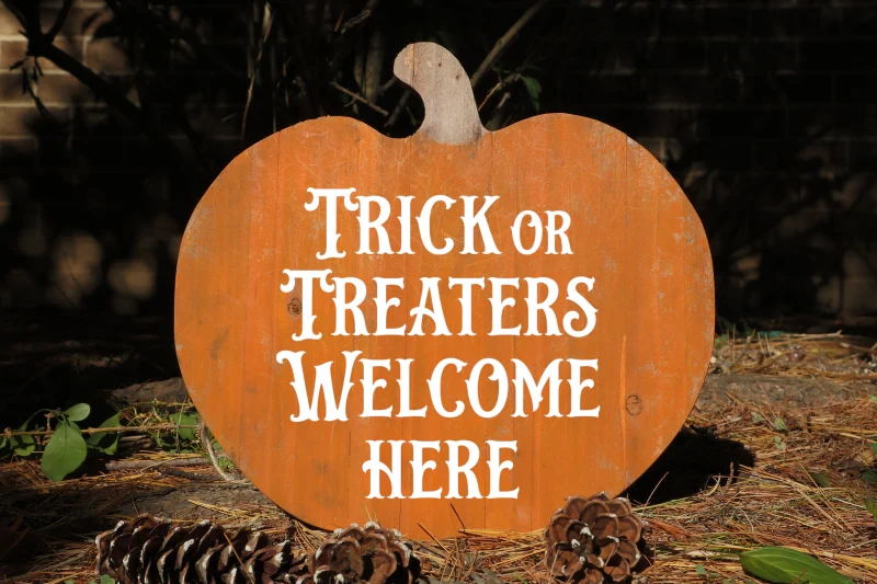 Trick or treaters welcome here. Orange wooden cedar pumpkin with out accent bow.