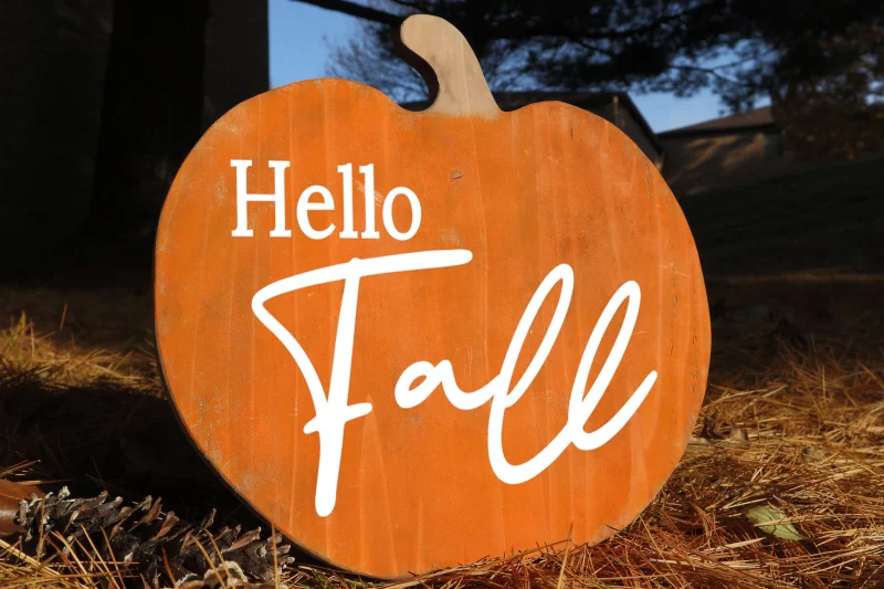 Hello fall. Pumpkin shaped orange wooden sign.