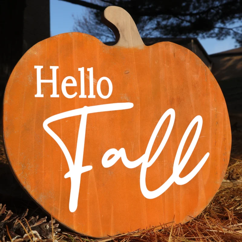 Hello fall. Pumpkin shaped orange wooden sign.