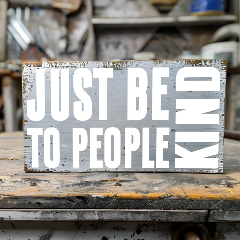 Just be kind to people. Gray sign with white lettering